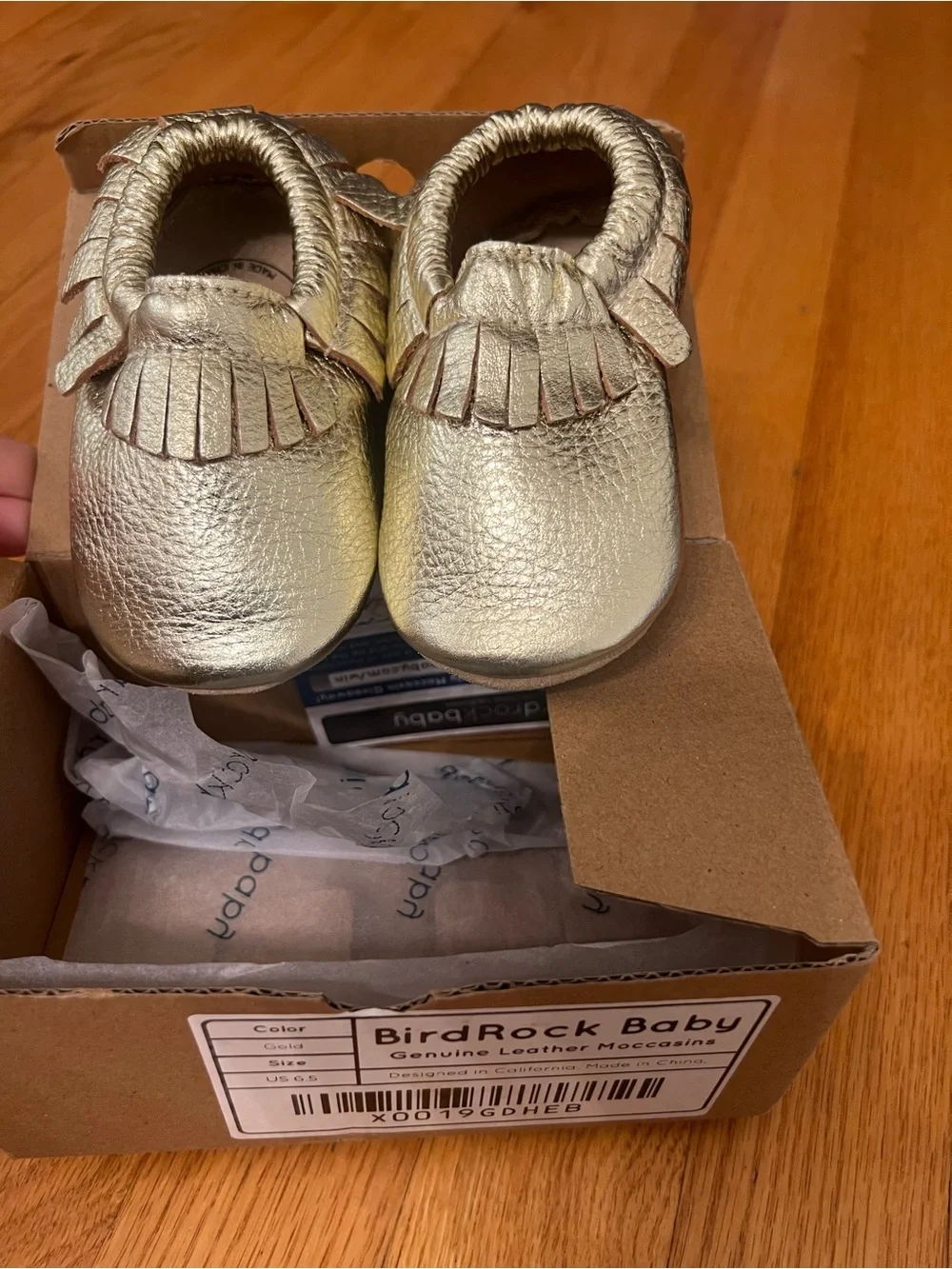 BirdRock Baby genuine leather moccasins feature a shiny gold shoes